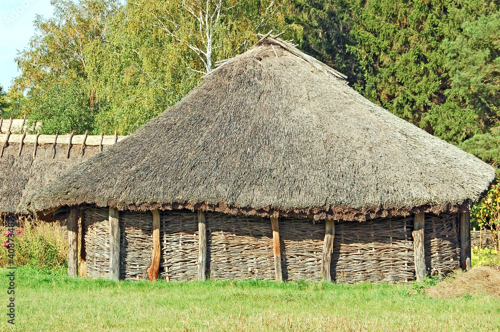 Ancient traditional ukrainian rural barn with a straw roof