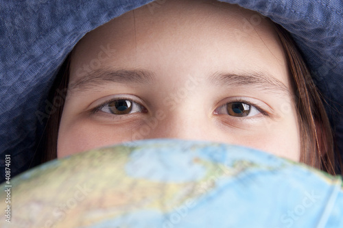 school age girl with globe foreground