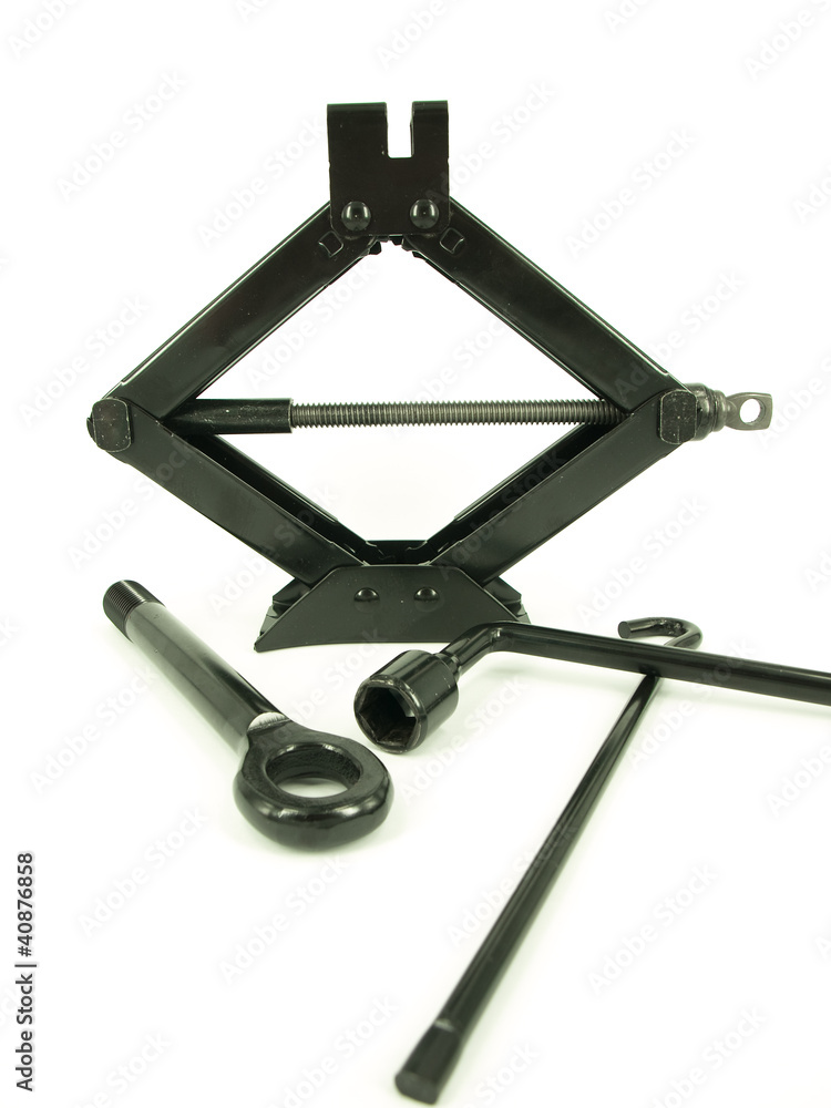 Car jack and basic tool over the white background Car jack and basic tool over the white background
