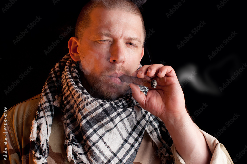Soldier puffing some good cigar smoke, black background Stock Photo ...