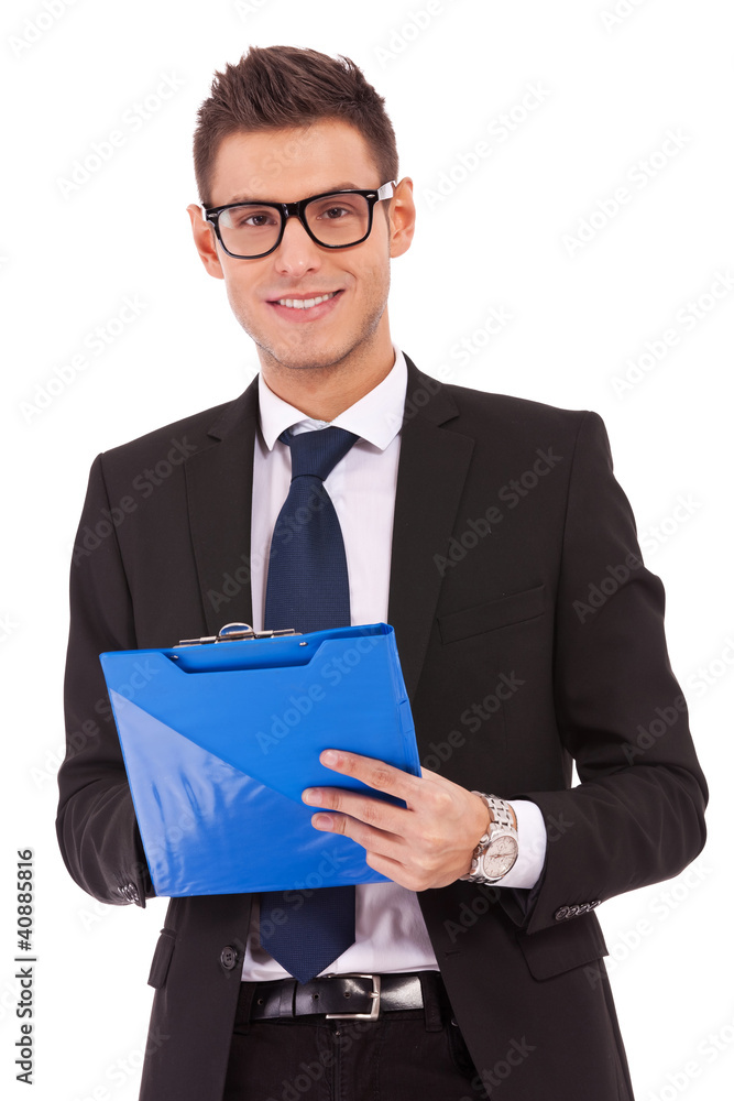 business man wearing glasses is writing on clipboard business man wearing glasses is writing on clipboard