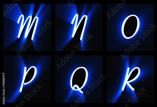 The letters on a black background in blue light