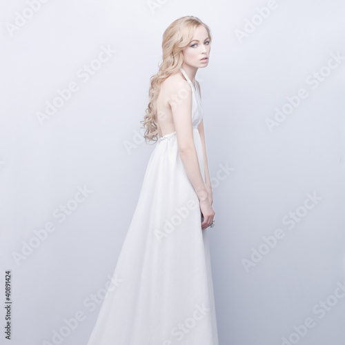 portrait of beautiful elegant blond woman in white dress