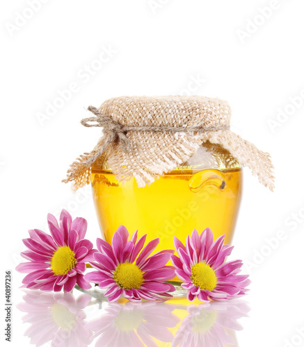 Sweet honey in jar isolated on white