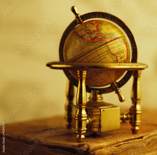 Globe standing on a vintage book.
