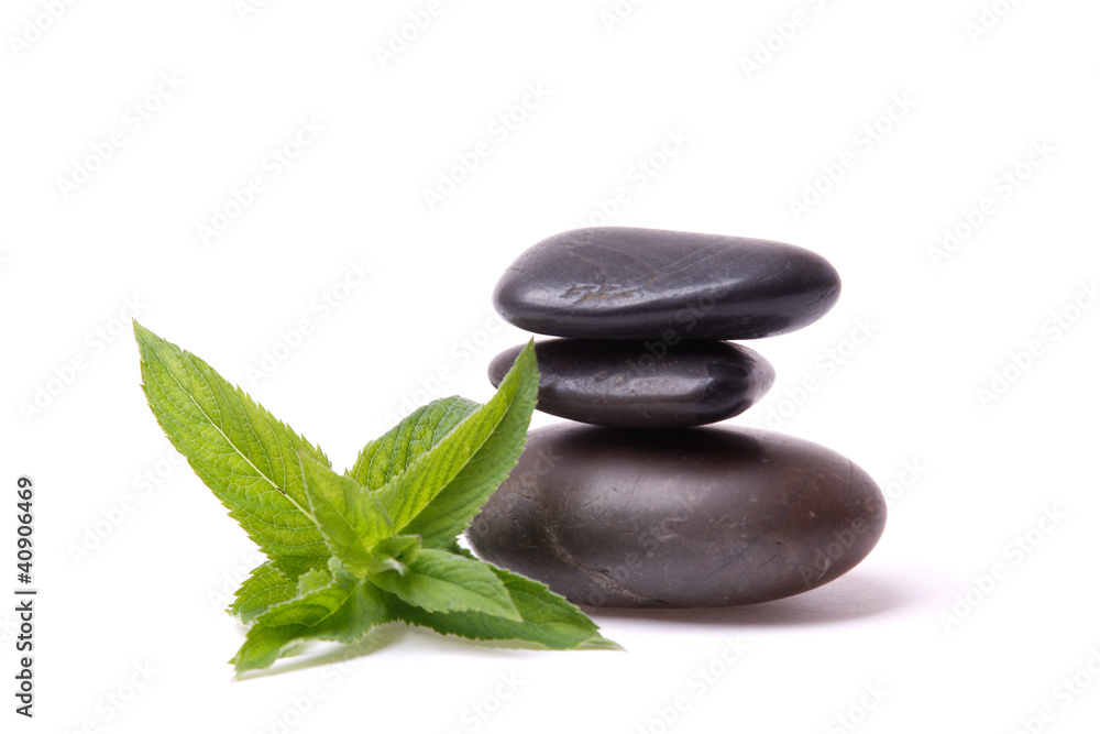 A peppermint and a stack of stones on white background A peppermint and a stack of stones on white background
