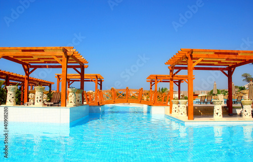 Luxury swimming pool and pergola in resort hotel