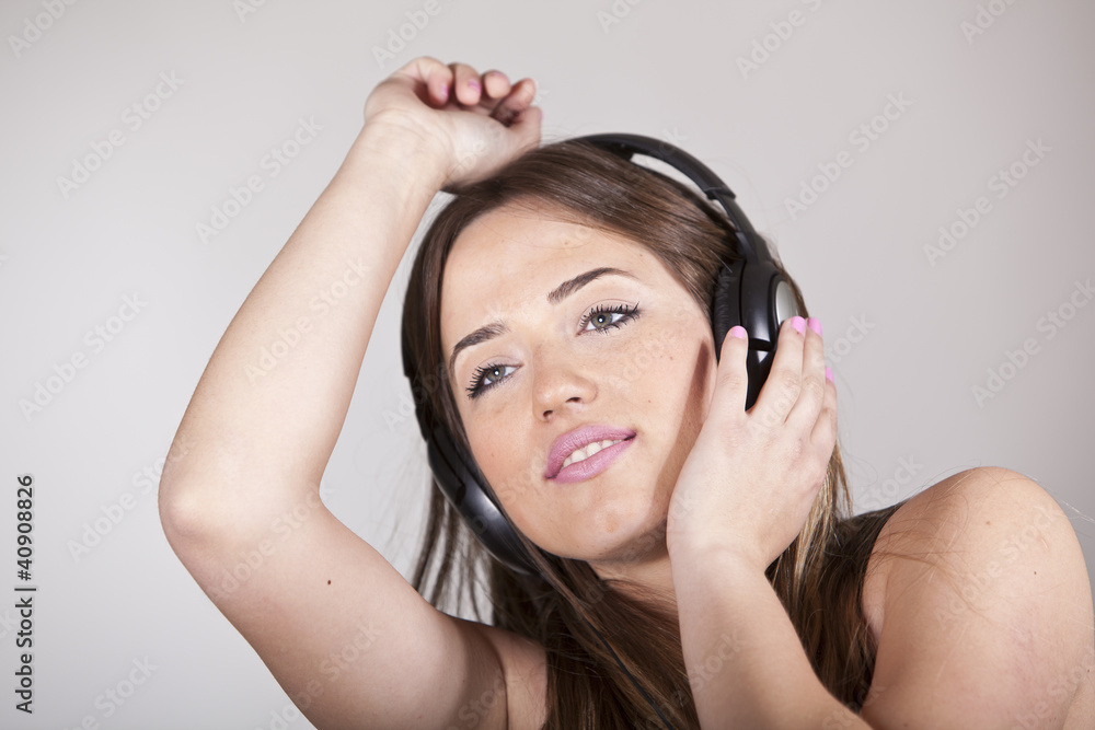 Beautiful cheerful young woman enjoying music Beautiful cheerful young woman enjoying music