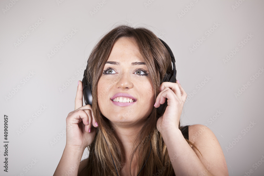 Beautiful cheerful young woman enjoying music Beautiful cheerful young woman enjoying music