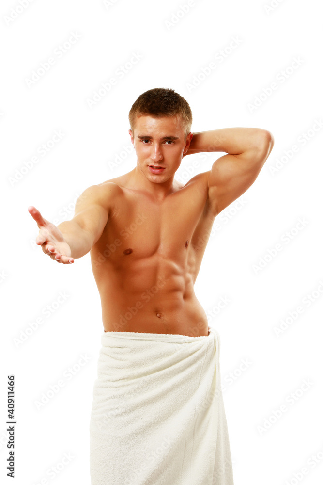 Fototapeta premium Muscle young man posing wrapped in white towel isolated
