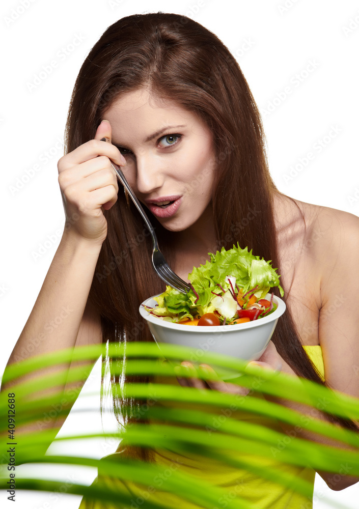 The beautiful cheerful young woman has breakfast salad The beautiful cheerful young woman has breakfast salad