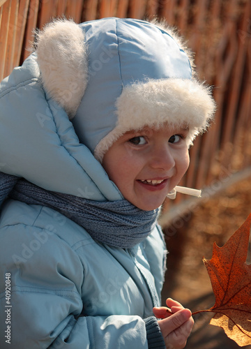 A child with fall foliage.