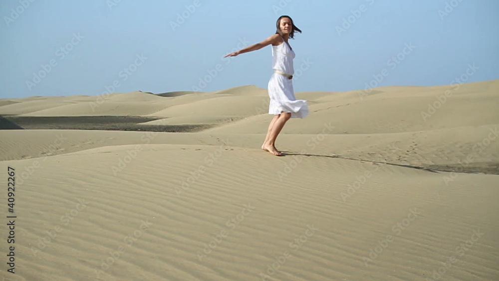 Carefree young woman running in the desert, slow motion Carefree young woman running in the desert, slow motion
