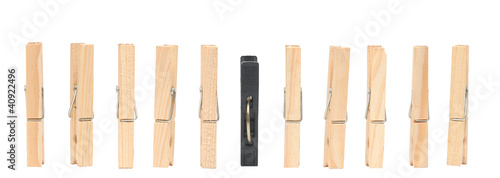 old wooden pins and one black plastic pin isolated on white