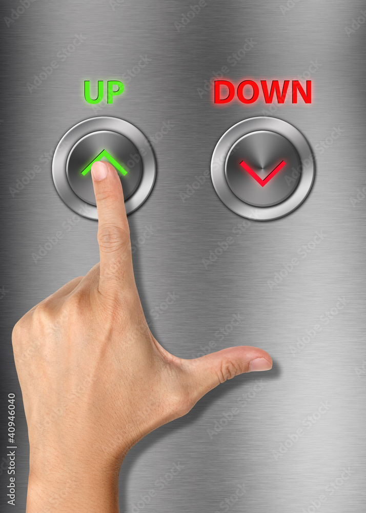 Fototapeta premium Human hand pressing up button on metalic background