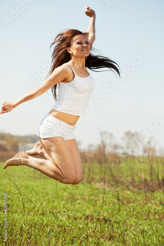Jumping mid adult woman