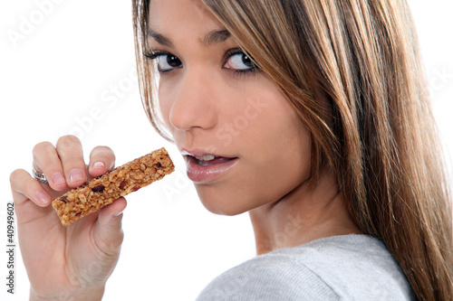 Woman eating a cereal bar