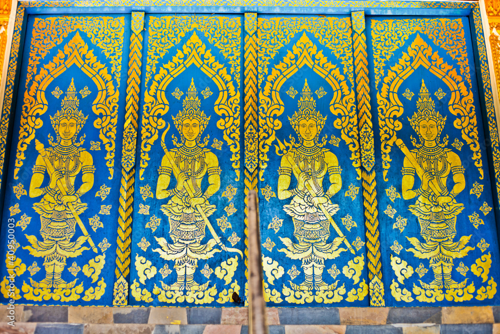 thai temple  doors with angels on blue background