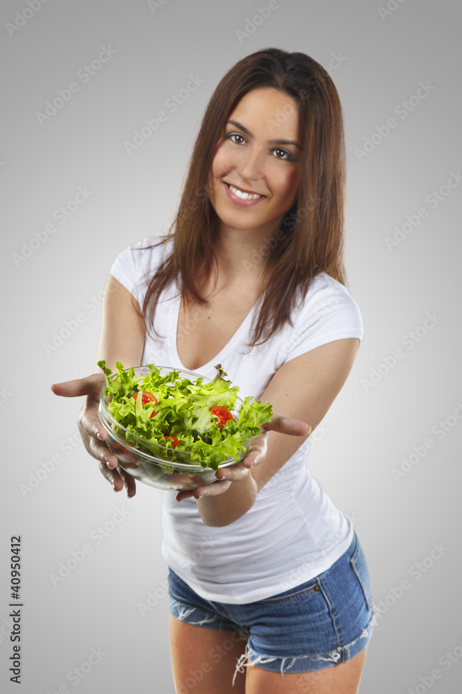 beautiful smiling woman holding a salad over isolated background beautiful smiling woman holding a salad over isolated background