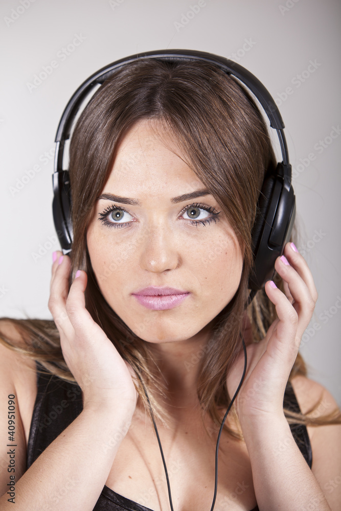 Beautiful cheerful young woman enjoying music Beautiful cheerful young woman enjoying music