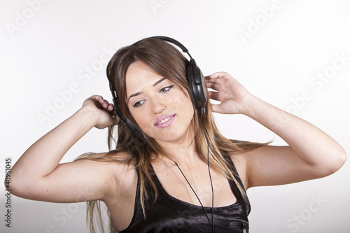 Beautiful cheerful young woman enjoying music