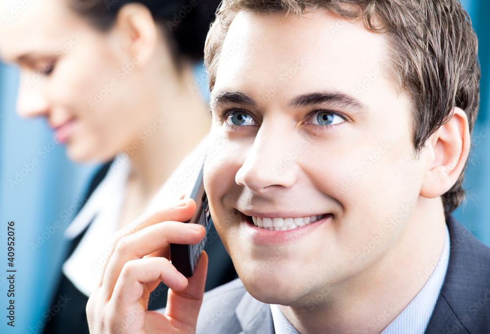 Businessman with cellphone at office Businessman with cellphone at office