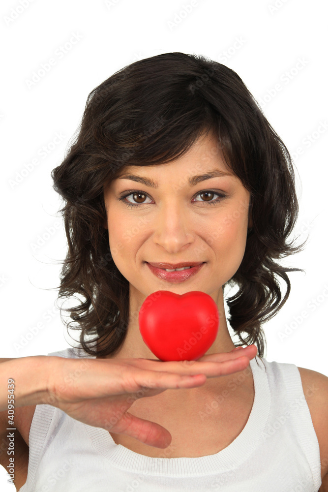 Brunette girl with heart in hand Brunette girl with heart in hand