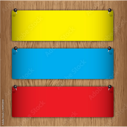 Announcement label on wood board with pin.