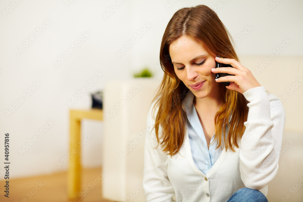 Charming woman speaking on the phone at home Charming woman speaking on the phone at home