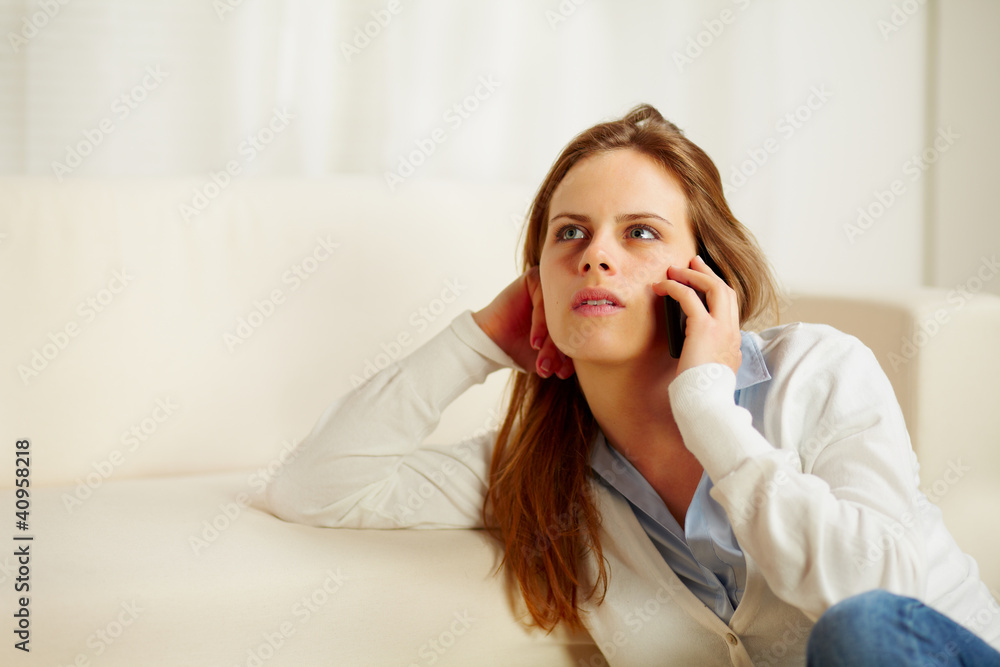 Young woman on mobile phone and looking up Young woman on mobile phone and looking up