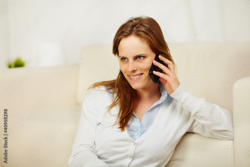 Young lady enjoying conversation on cell phone Young lady enjoying conversation on cell phone