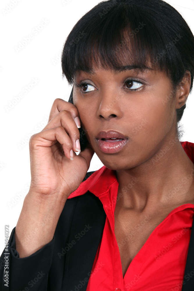 An African American businesswoman getting bad news. An African American businesswoman getting bad news.