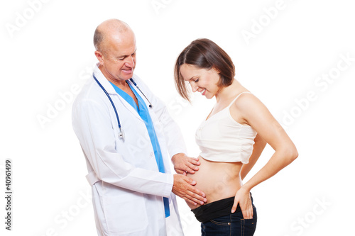 studio shot of smiley pregnant woman and doctor
