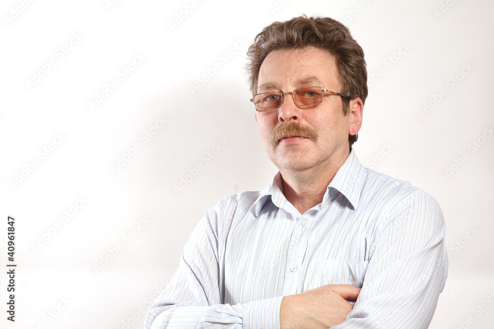 An adult businessman wearing eyeglasses and moustache An adult businessman wearing eyeglasses and moustache