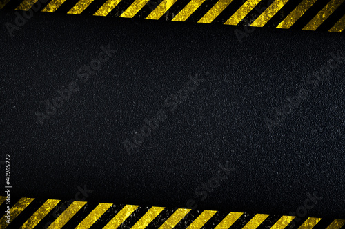 Dark background with yellow caution stripes photo