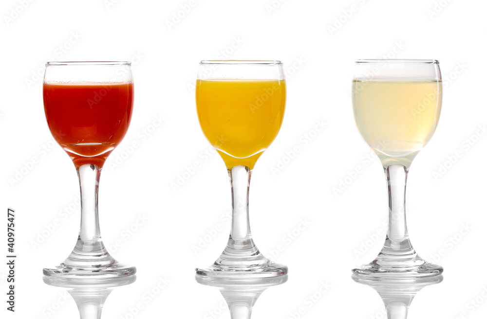 Tropical juices in glasses isolated on white Tropical juices in glasses isolated on white