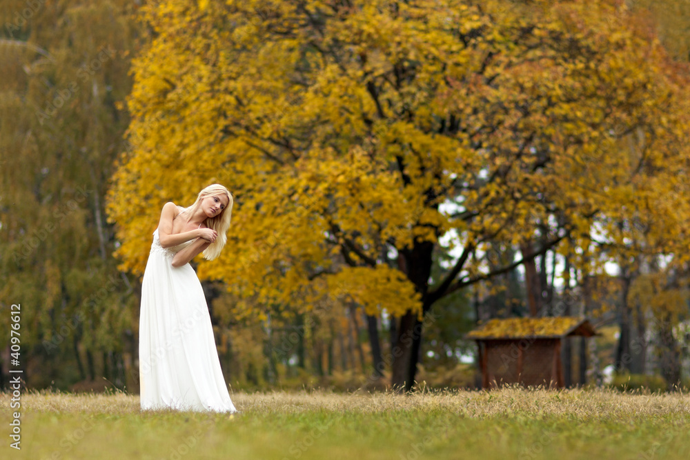Beautiful young woman in white dress