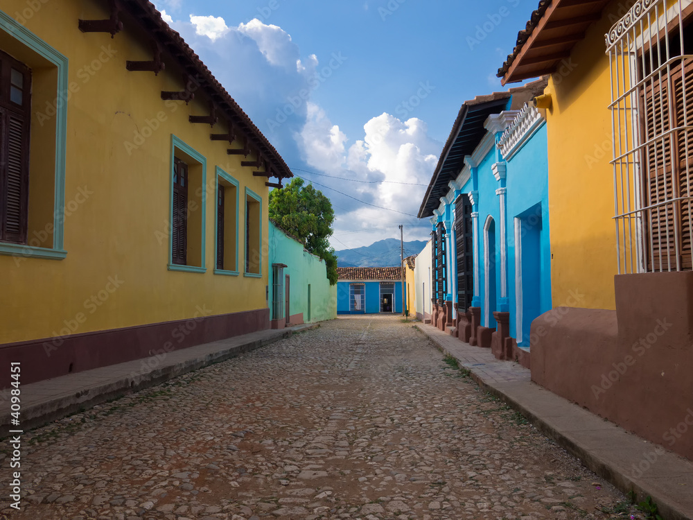 Narrow street and colorful houses in Trinidad , Cuba