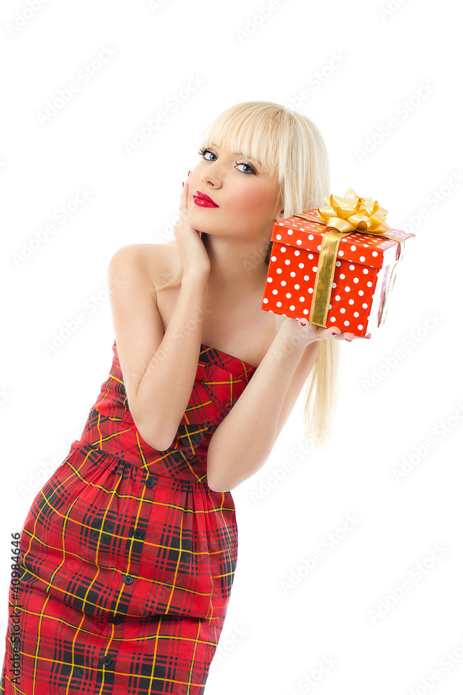 Beautiful young blonde girl holding christmas gift in red dress Beautiful young blonde girl holding christmas gift in red dress