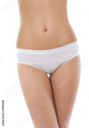 Fit body of beautiful young woman in panties on white background