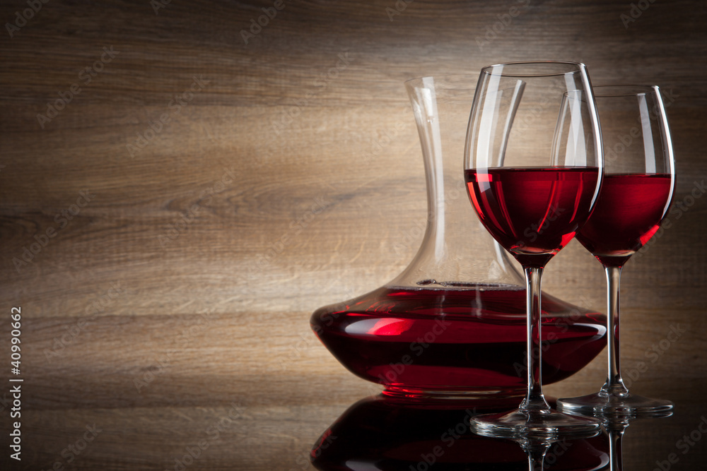 two Wine glass and decanter on a wooden Background