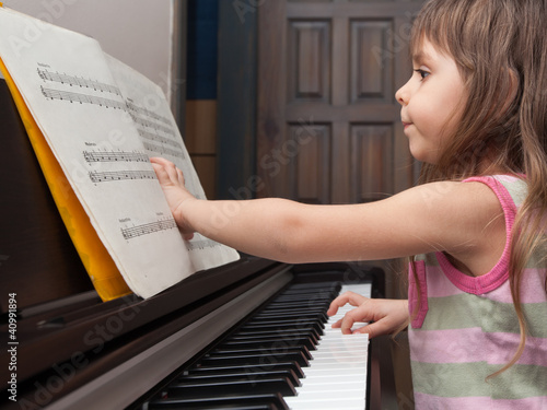 Little girl playing the piano