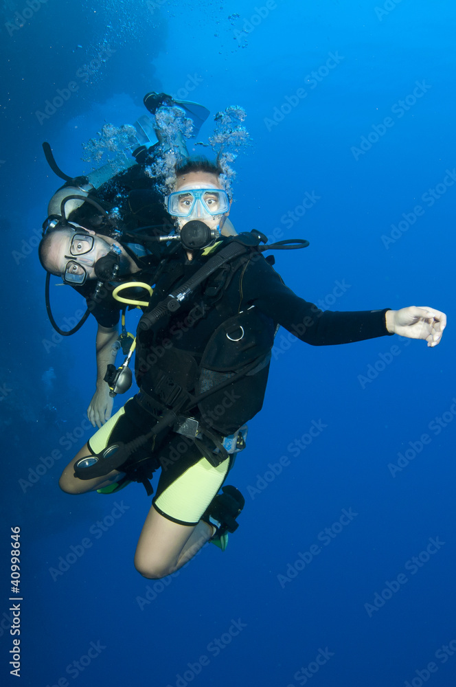 man and woman scuba dive togeather man and woman scuba dive togeather