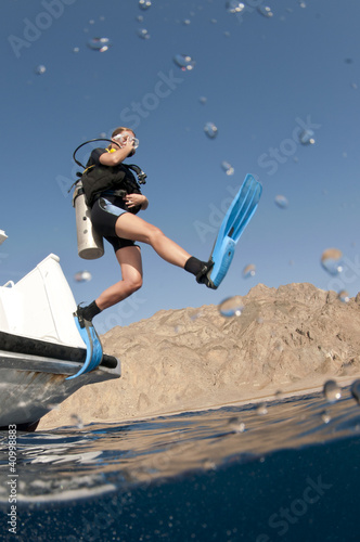 scuba diver jumps off boat