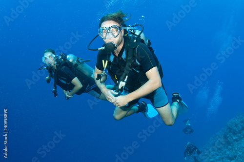 man and woman scuba dive togeather