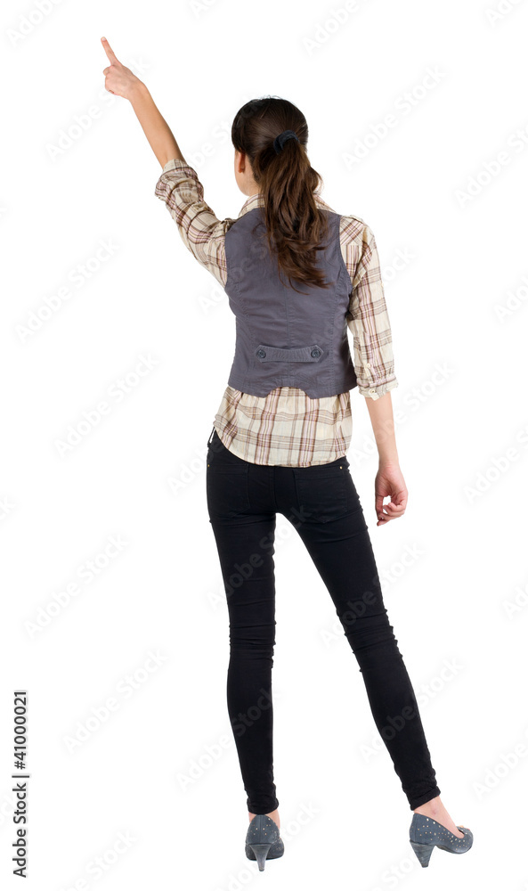 Back view of young brunette woman pointing Back view of young brunette woman pointing