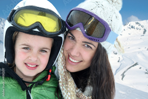 Mother and daughter skiing in the mountain © goodluz