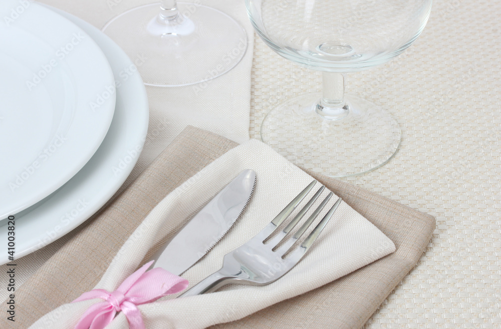 Table setting with fork, knife, plates, and napkin Table setting with fork, knife, plates, and napkin