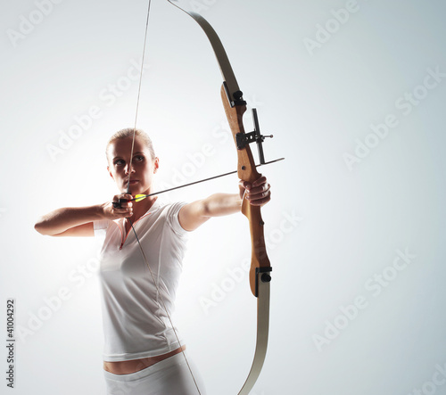 Print op canvas Beautiful woman aiming with bow and arrow
