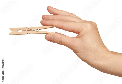 clothes pin in hand, isolated on white background